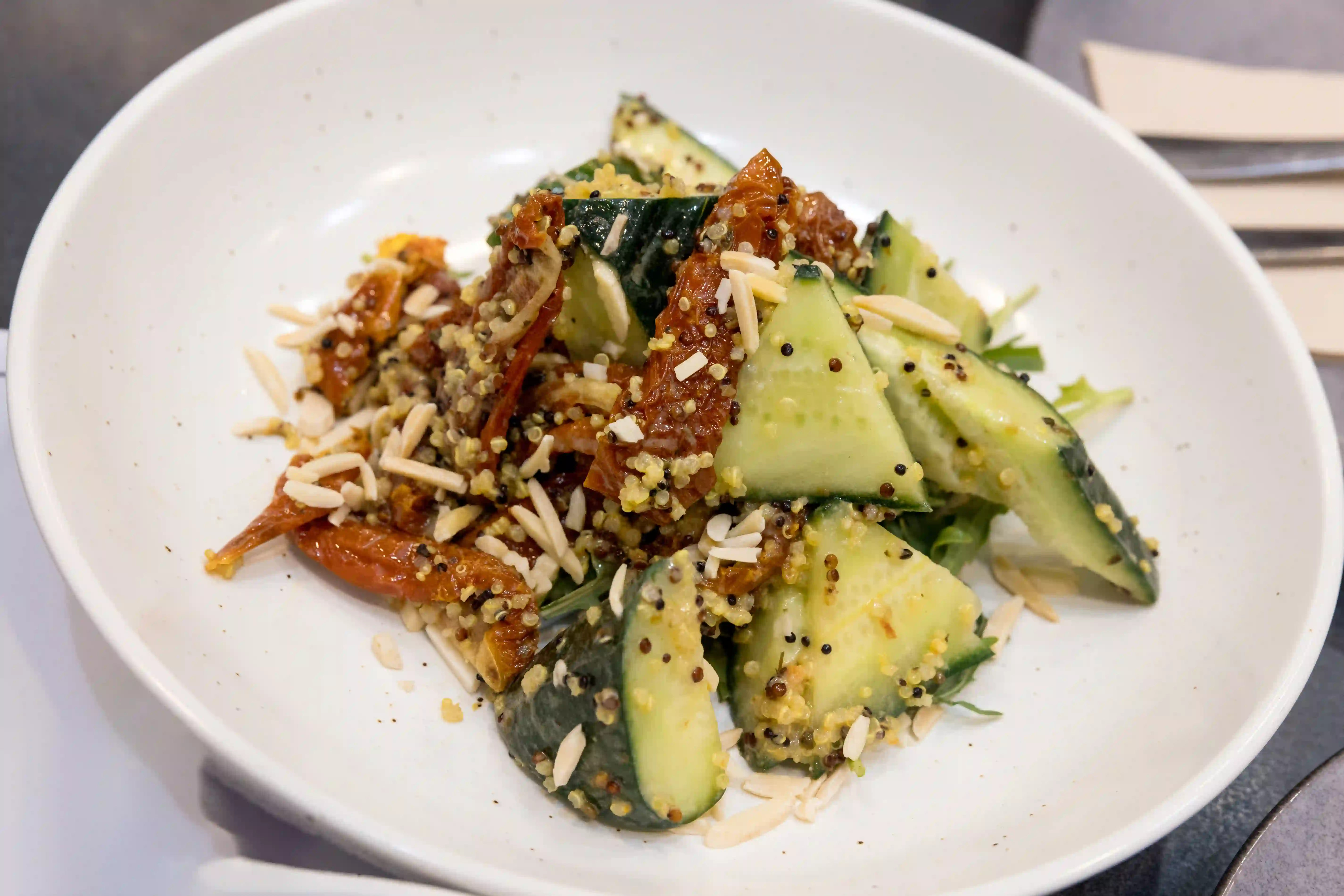 Salad of Sun Dried Tomato, Cucumber, Almonds, Rocket, Quinoa, Tahini Dressing