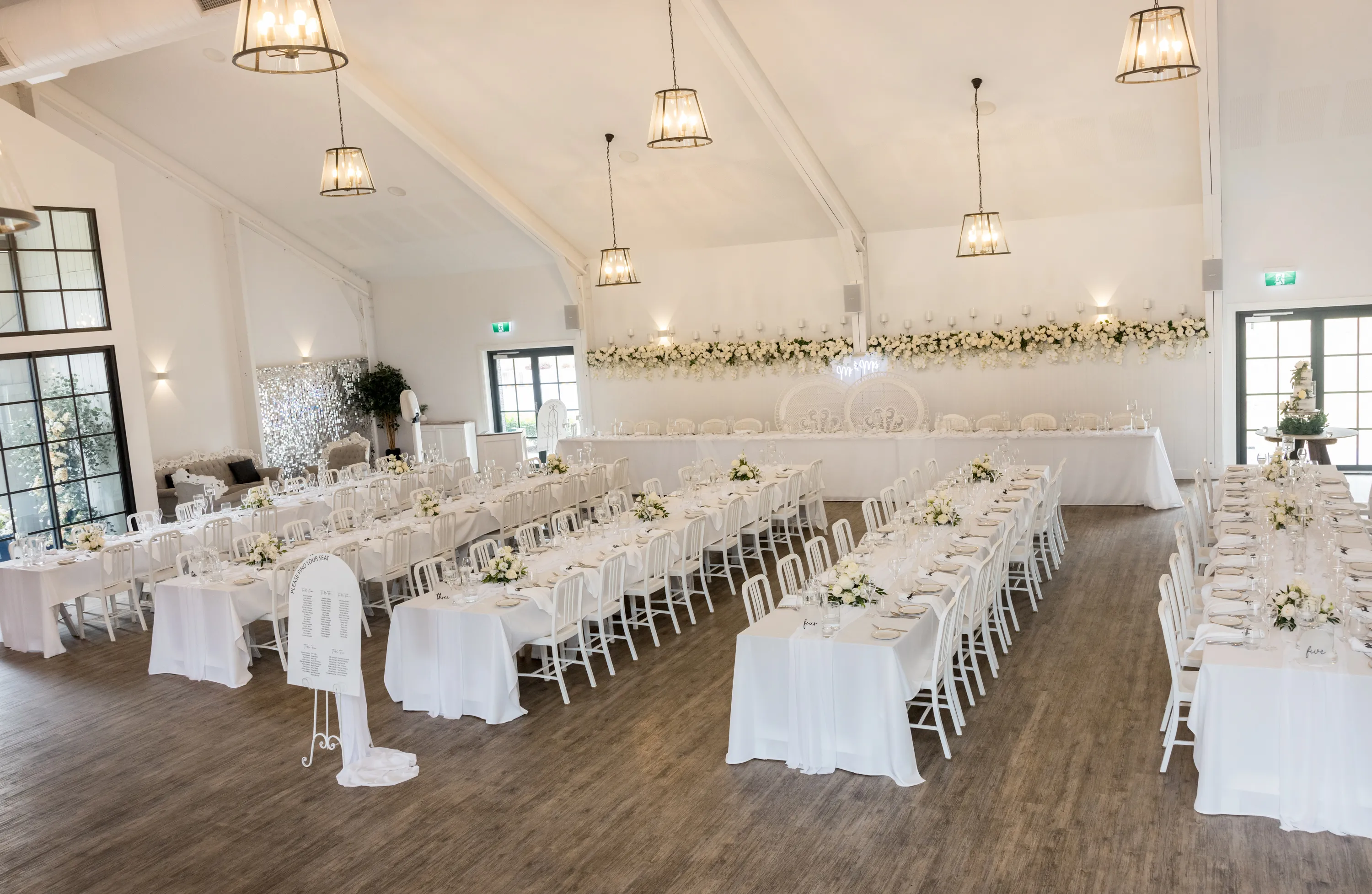 Interior image of the White Barn Pokolbin featuring tables, chairs and florals