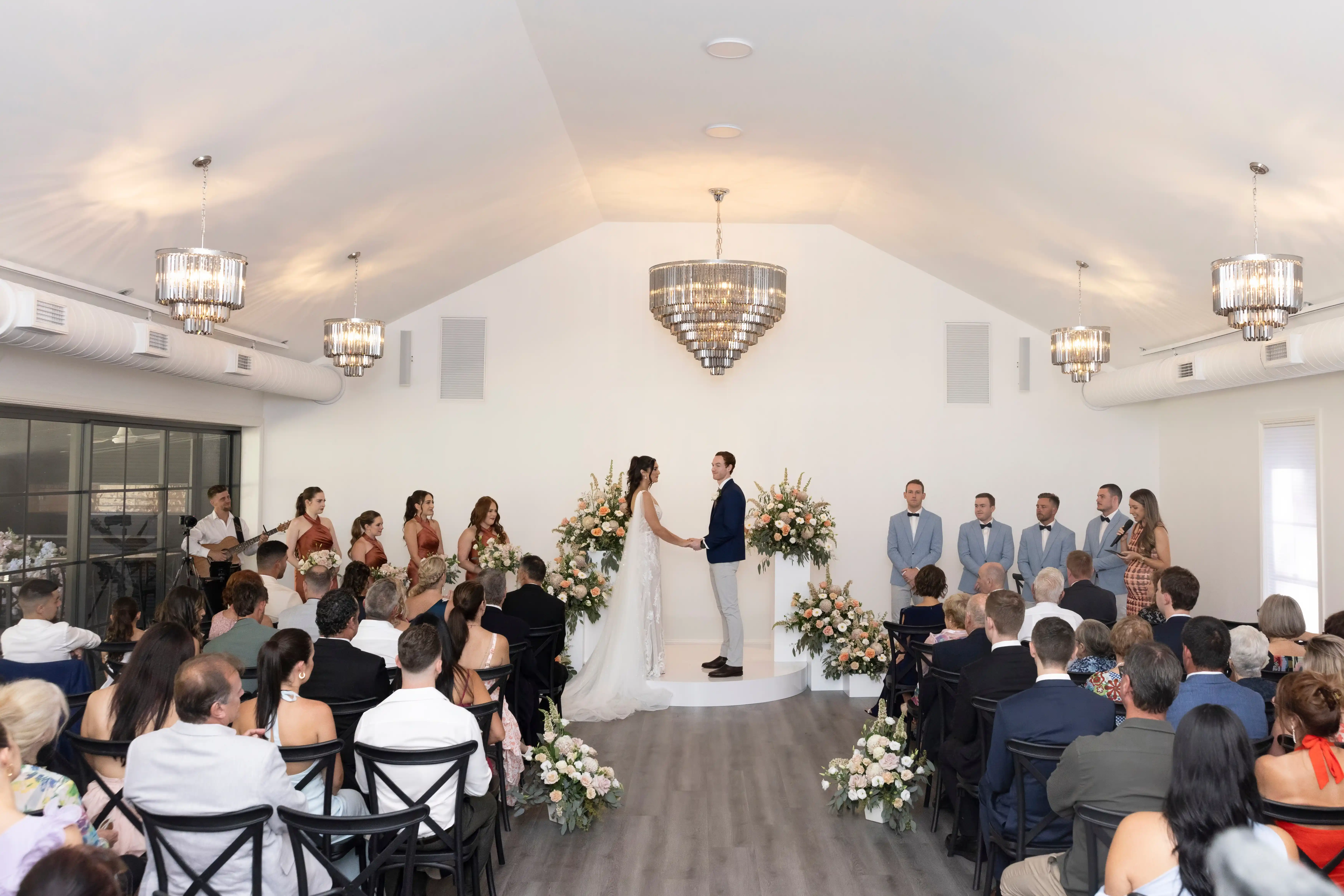 Hunter Valley indoor wedding ceremony with guests seated toward the silk arbour