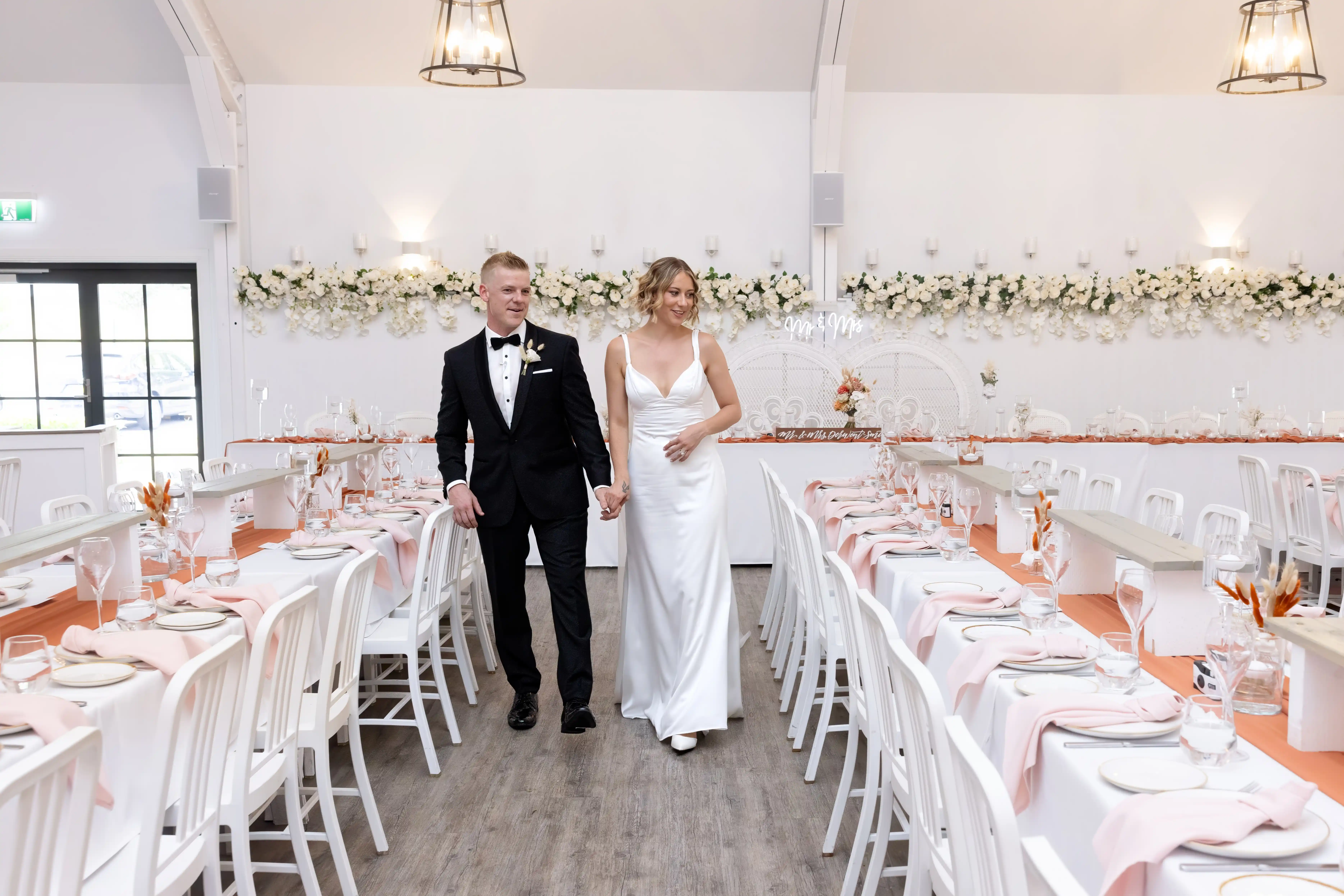 White Barn reception interior with timber beams and celebration styling