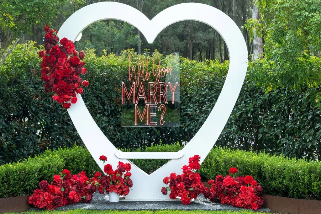Love heart arch with red silk roses in the White Barn garden